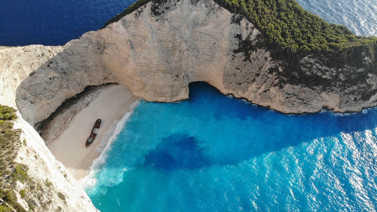 Aerial view of Navagio Beach with a shipwreck on white sand and vivid blue water