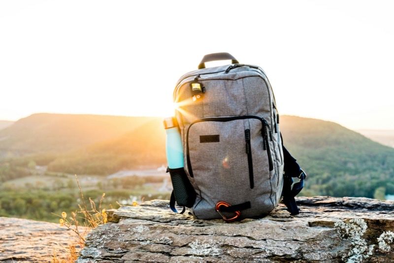 Backpack on a rock at sunrise