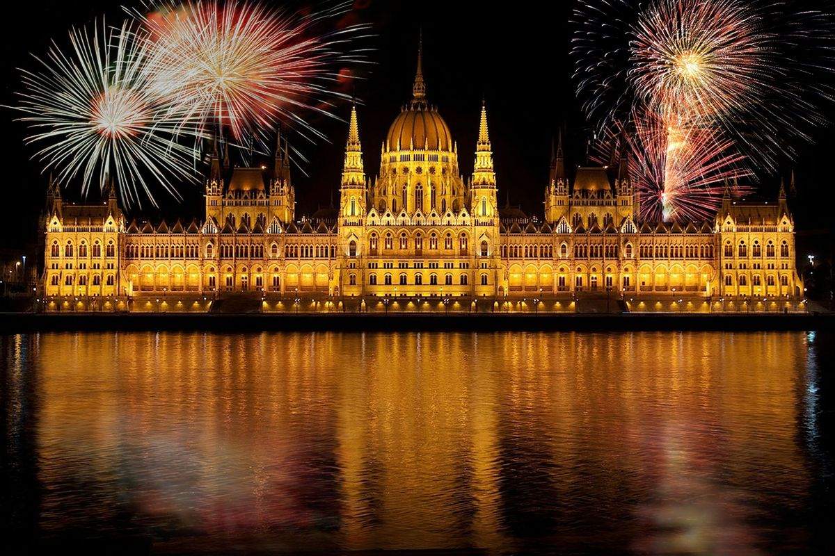 Fireworks above the Hungarian Parliament Building reflected in the Danube at night