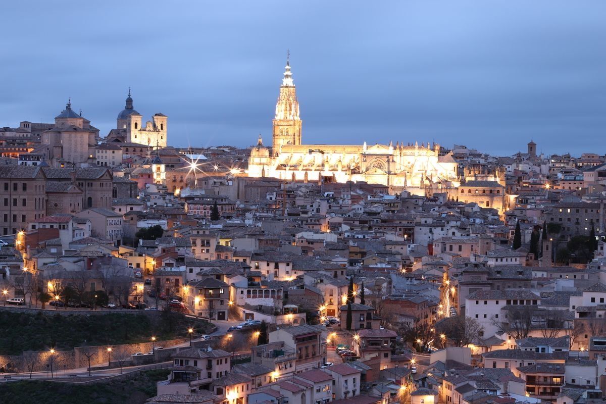 Toledo skyline at twilight with the illuminated cathedral rising above the old city