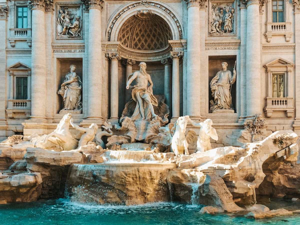 Trevi Fountain with marble statues, cascading water, and the ornate Baroque facade behind