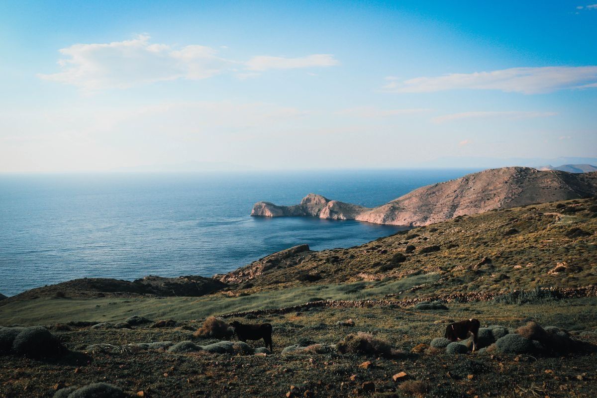 Rocky hills overlooking a calm blue sea on the coast of Agios Stefanos