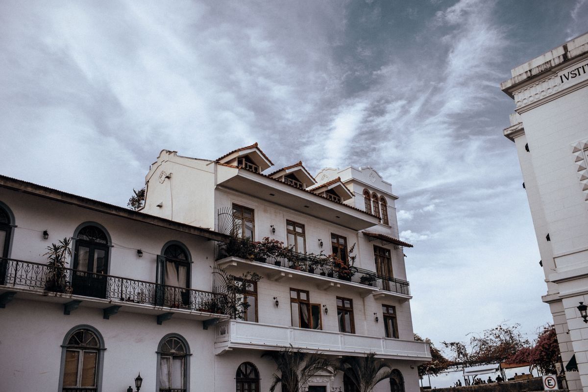 Colonial buildings with balconies in Casco Viejo beneath a dramatic cloudy sky