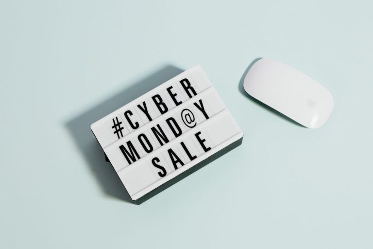 Cyber Monday Sale sign next to a wireless mouse