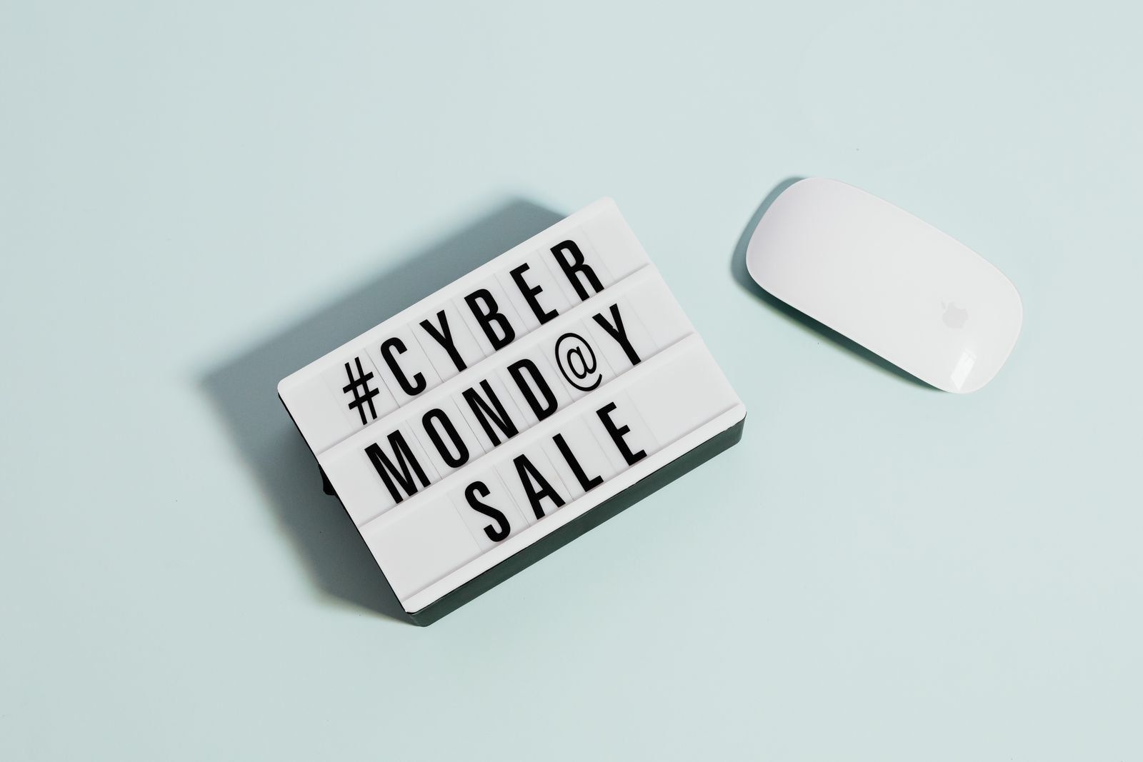 Cyber Monday Sale sign next to a wireless mouse