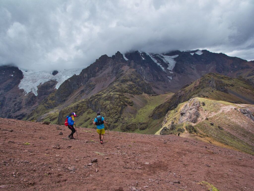 Two hikers walking through the Andes mountains near Cusco, Peru