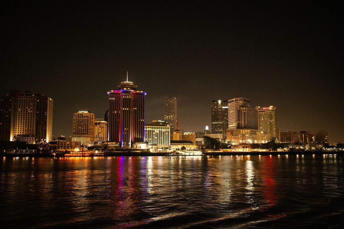 New Orleans skyline at night reflected on the Mississippi River