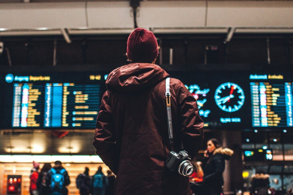 Traveler looking at the departures board in an airport